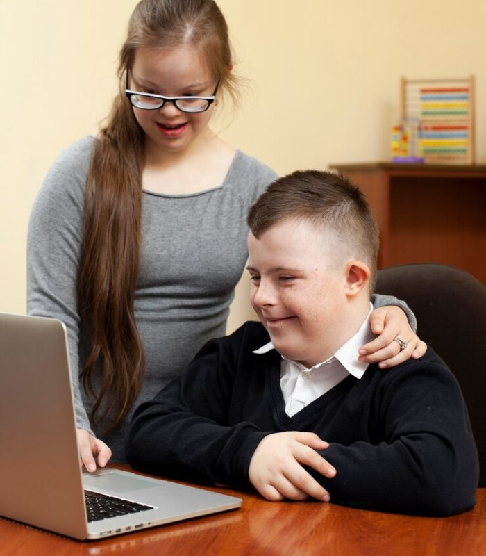 boy-girl-with-down-syndrome-looking-laptop_23-2148464656